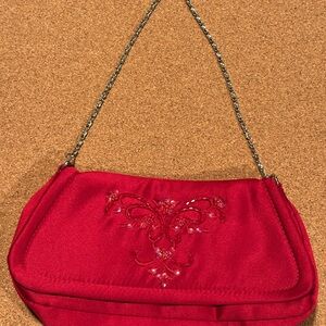 Red purse with beaded design and snap closure